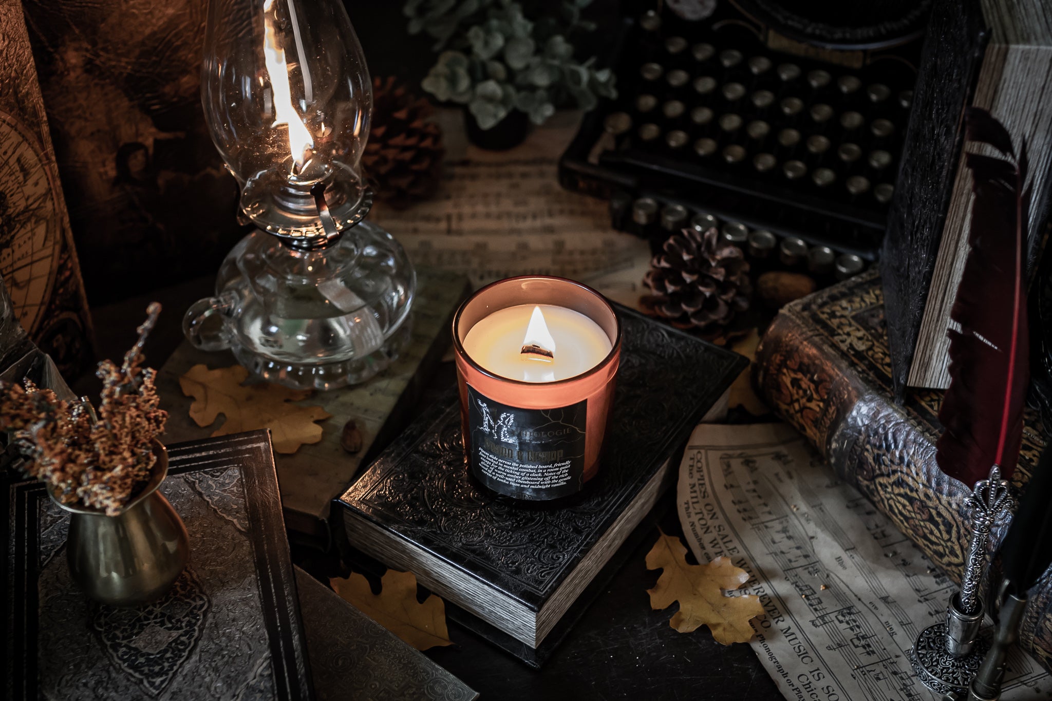 dark academia candle, type writer, and lamp